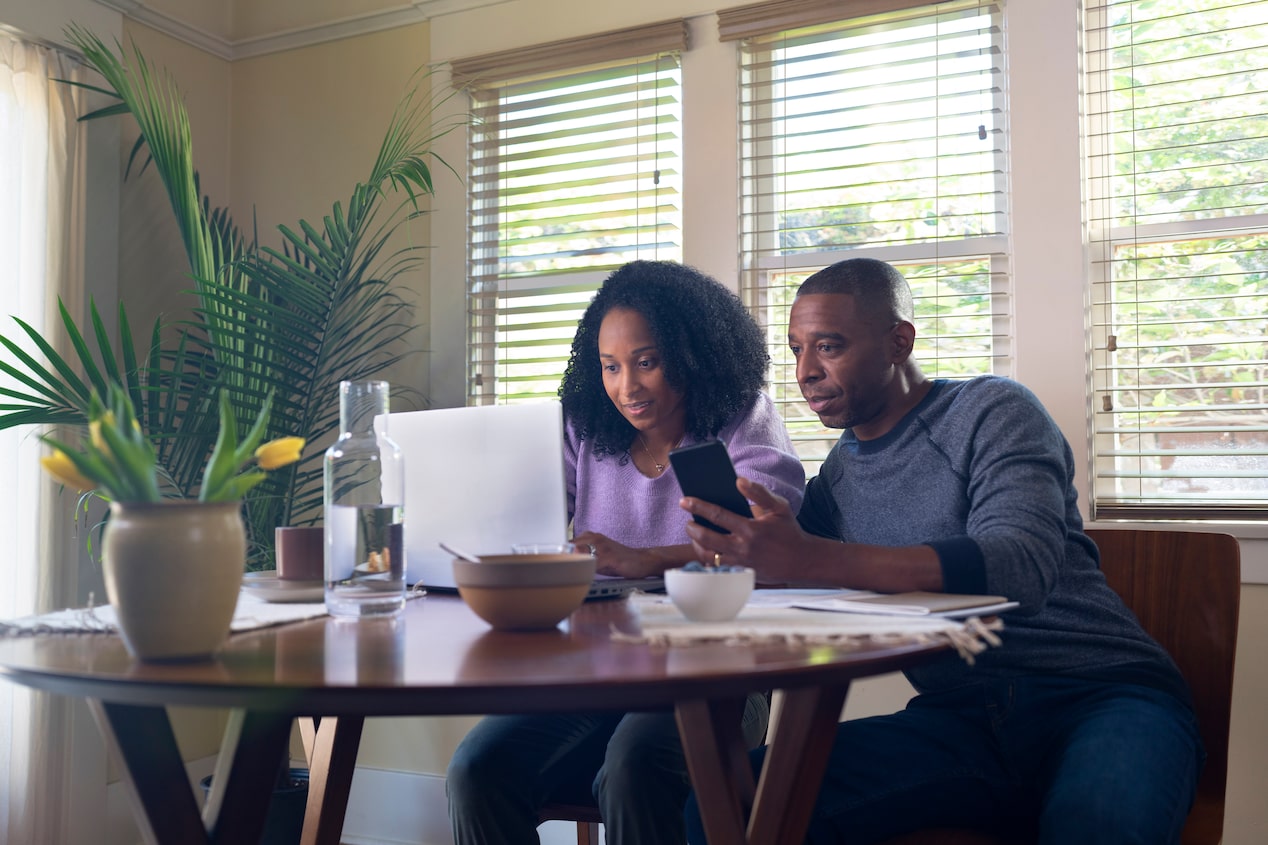 Couple Using Laptop for Flexible Shopping Options on Certified Used Vehicles