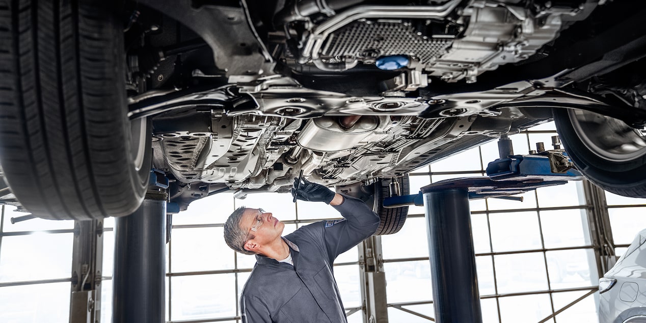 Buick Certified Service Technician Inspecting Underside of a Vehicle