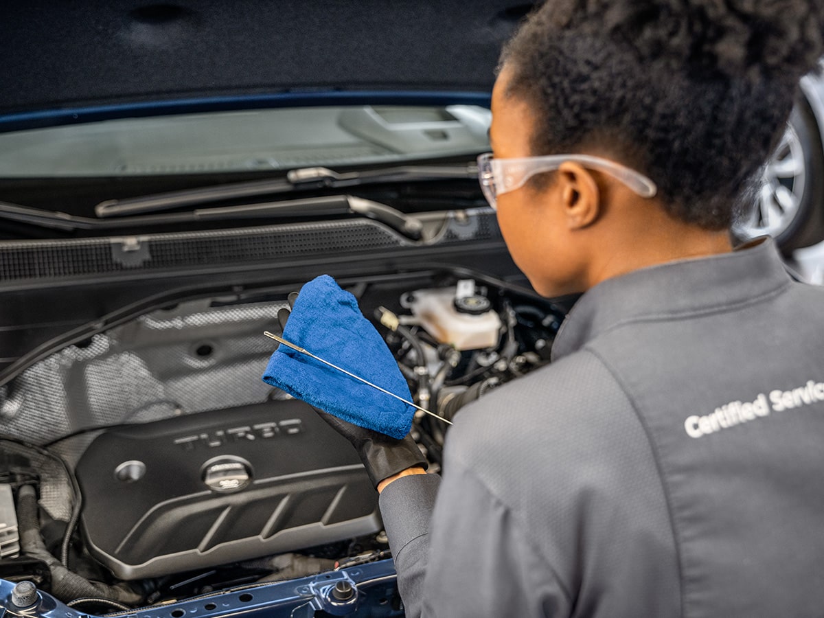 A Buick Certified Service Technician Performing an Oil Change