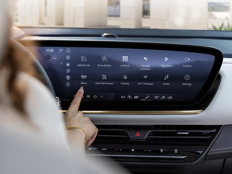 Over the Shoulder View of a Woman Using the Touch Screen on the Buick Infotainment Screen