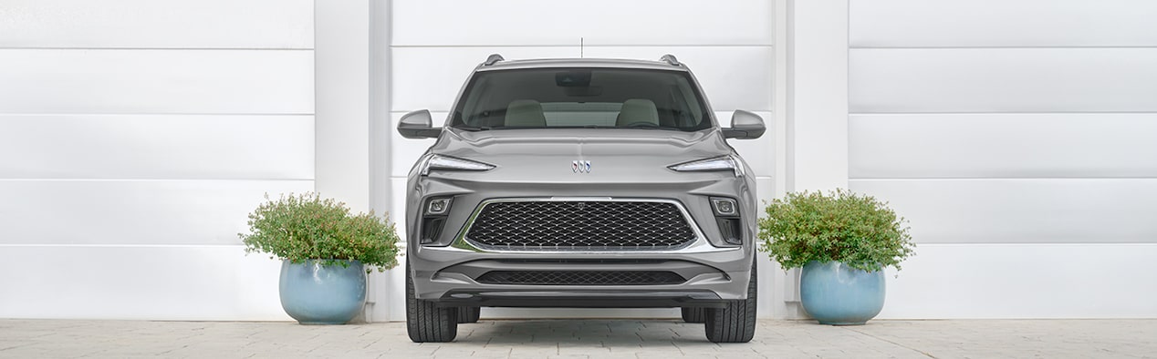 Grey Buick SUV Parked in Front of White Garage Door